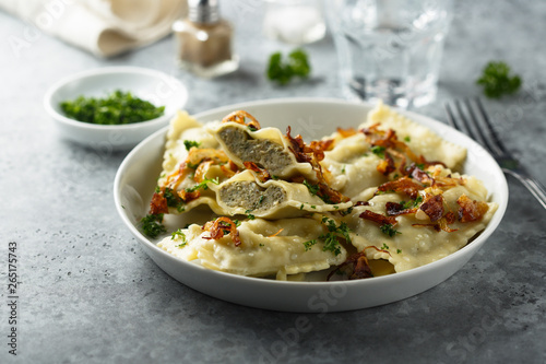 Traditional German dumplings with fried onion and herbs