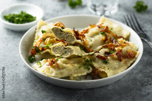 Traditional German dumplings with fried onion and herbs