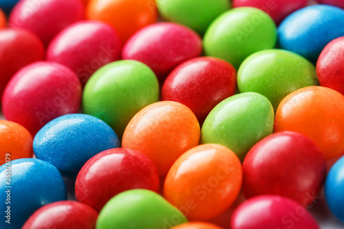 Rainbow colors of multicolored candies close-up  texture and repetition of dragee
