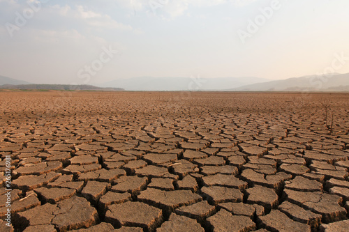 Dry river and lake after drought impact on summer, Landscape of Cracked earth metaphor climate change and drought