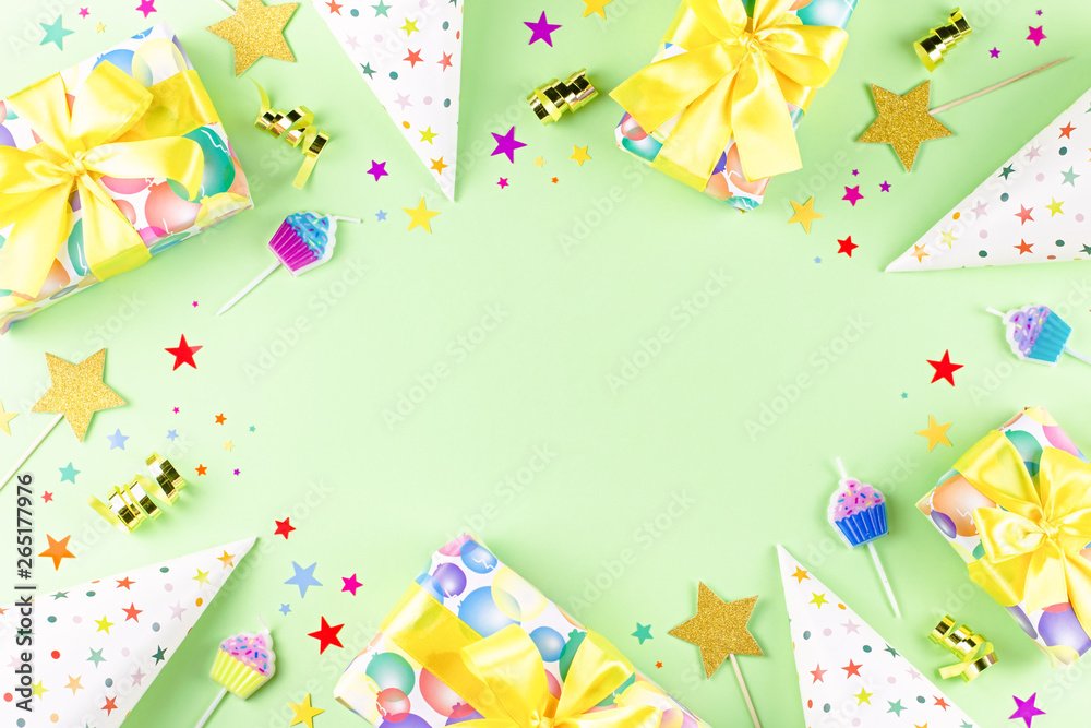 Fototapeta premium Birthday party background with wrapped gifts, confetti, party hats, decorations, top view