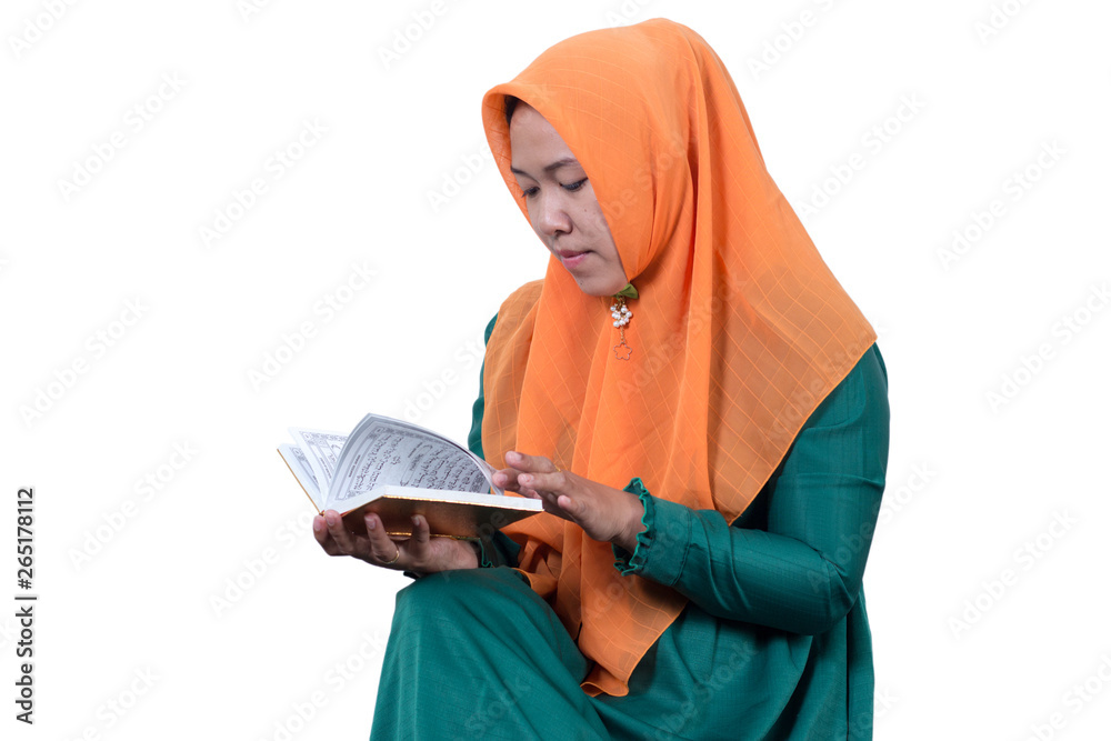 Portraits of young Asian Muslim business women wearing hijab  And Reading The Holy Quran, isolated on white background