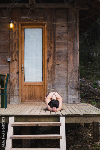 Woman doing yoga in the yard.