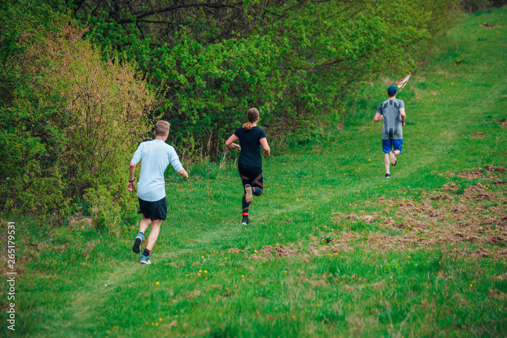 Trail runners in green spring nature Trail runners in green spring nature
