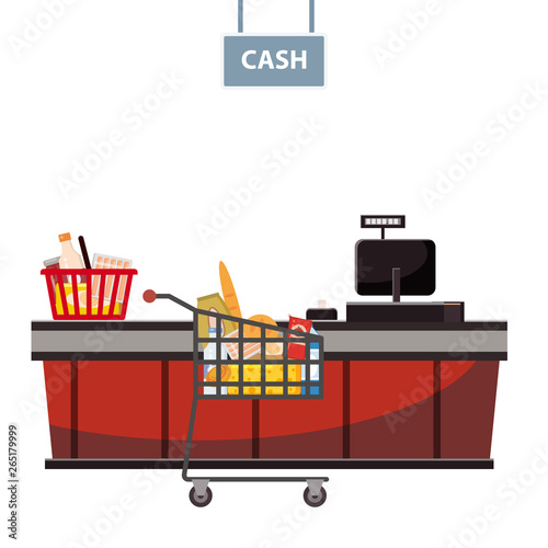 Cashier counter in the supermarket, shop, store with a basket full of groceries and grocery cart full of groceries