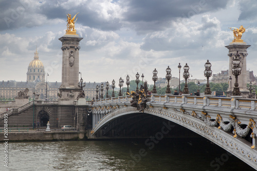 Pont Alexandre III bridge overlooking the city and the river, cloudy day. France Paris