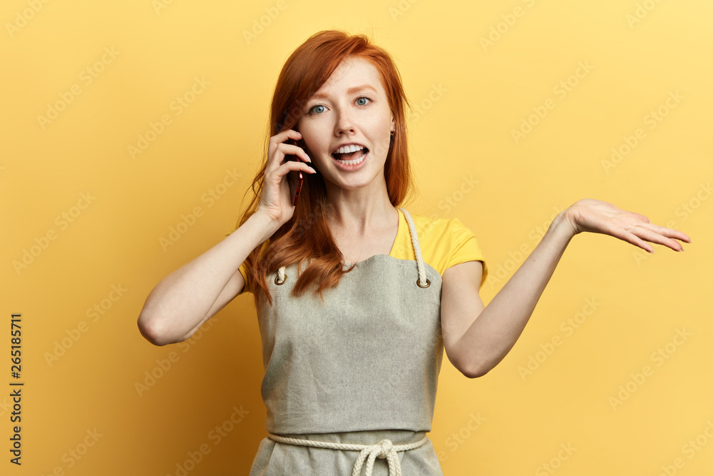 emotional girl with red long talking with her boyfriend, explaining him something. funny girl having conversation . close up portrait. isolated yellow background emotional girl with red long talking with her boyfriend, explaining him something. funny girl having conversation . close up portrait. isolated yellow background