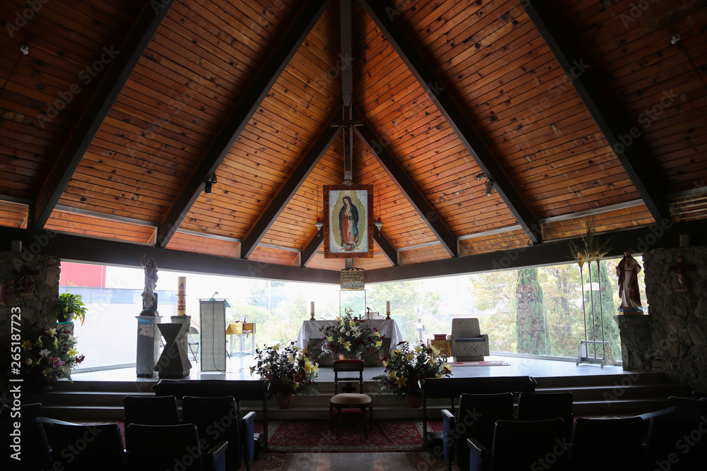 Interior de iglesia encristalada con virgen de Guadalupe el fondo y altar  Stock Photo | Adobe Stock