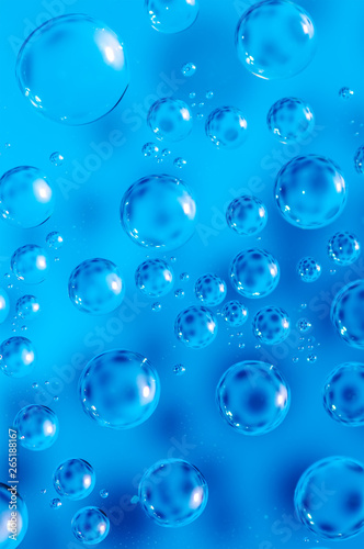 Macro air bubbles in water on a blue background