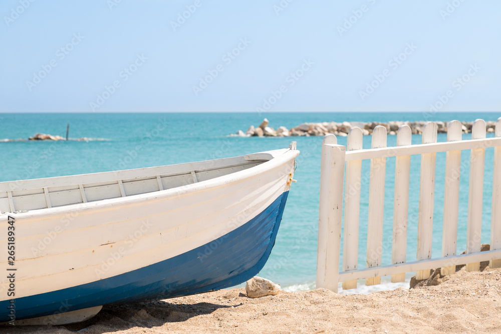 Summer photo of boat on sand and sea landscape. Wooden fishing boat on the beach with blue sky - Imagine
