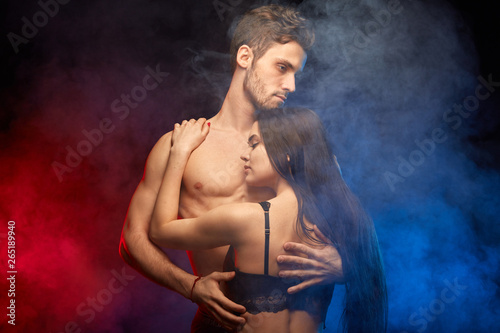 emotional relationship.awesome man cuddling with woman. close up photo. isolated smoky background