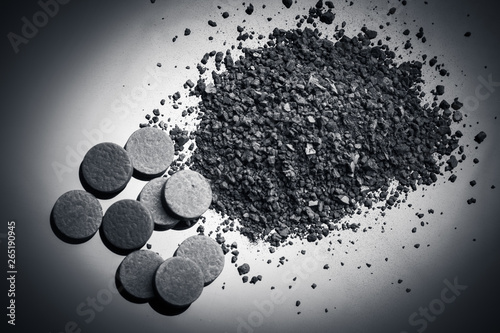 Top view activated carbon in crushed and in tablets photo