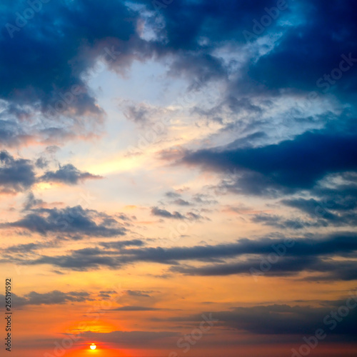 Cloudy sky and bright sun rise over the horizon. © alinamd