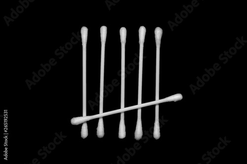 White cotton buds isolated on black background