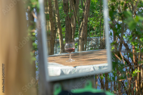 glass of red wine in mirror
