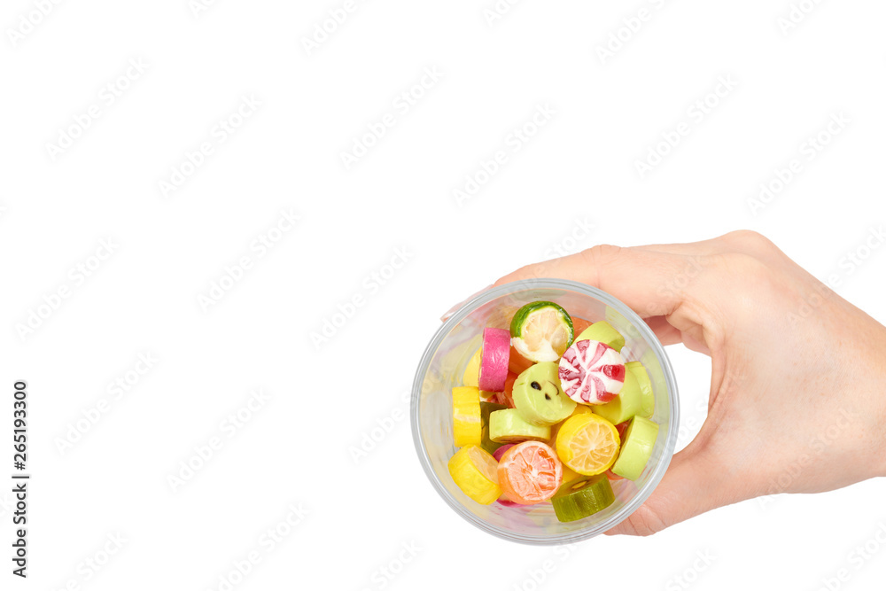 Hand with colored round candy, sugar lollipop Hand with colored round candy, sugar lollipop