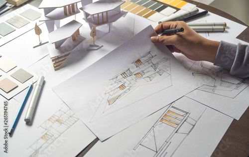 architect design working drawing sketch plans blueprints and making architectural construction model in architect studio