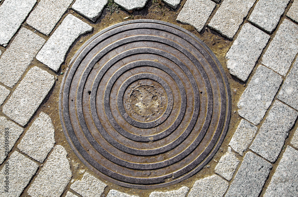 manhole cover on the rubble, repair work on the road