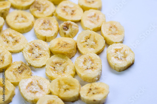 Close up slice yellow banana isolated on white background © syahrir