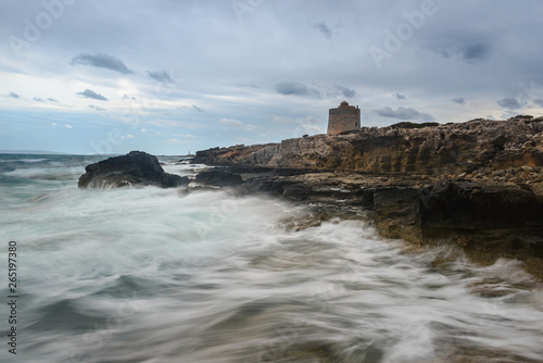 Rocky coast next to Ses Portes Tower, Ibiza island, Spain