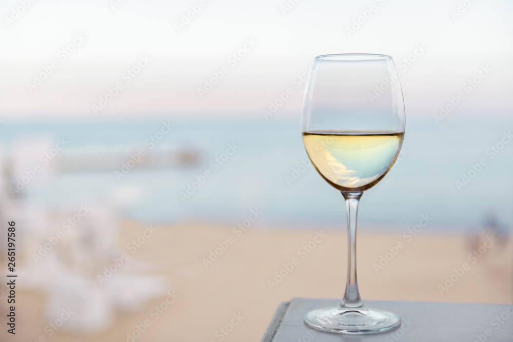 A glass of wine on the sea beach A glass of wine on the sea beach