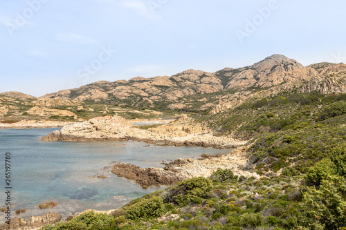jagged red rocks on the coast of the Desert des Agriates at Ostriconi in the Balagne region of Corsica, France