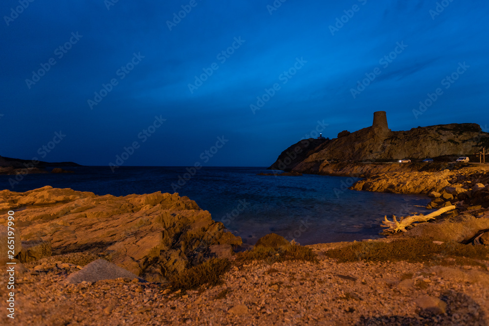 L'Île-Rousse with Torra di a Petra and lighthouse by night, Corsica, France