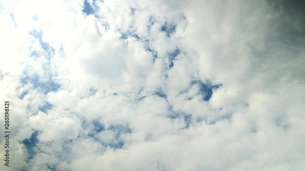Time lapse of cumulus clouds against a blue sky.