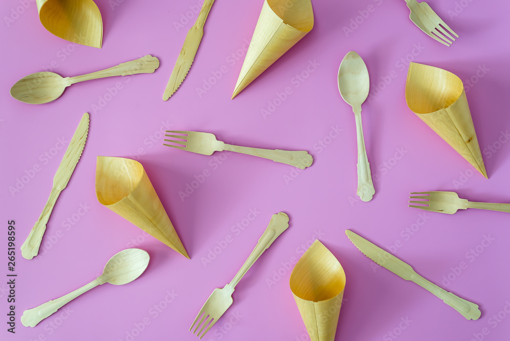 bamboo spoon and fork on pink or violet background bamboo spoon and fork on pink or violet background
