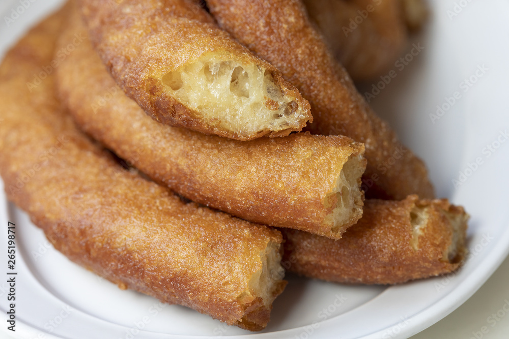 Close-up of delicious freshly made churros. Fried batons. (Porras madrileñas) Close-up of delicious freshly made churros. Fried batons. (Porras madrileñas)