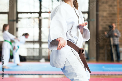 Female karate practitioner body position during competition. Martial arts.