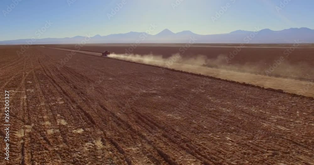 SALAR DE TARA, ATACAMA DESERT, CHILE - JUNE 2016. A bumpy off-road ride into a wide expanse of desert. Aerial 4K view over the bare deserted ground. SALAR DE TARA, ATACAMA DESERT, CHILE - JUNE 2016. A bumpy off-road ride into a wide expanse of desert. Aerial 4K view over the bare deserted ground.