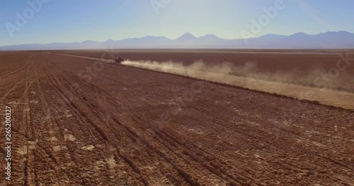 SALAR DE TARA, ATACAMA DESERT, CHILE - JUNE 2016. A bumpy off-road ride into a wide expanse of desert. Aerial 4K view over the bare deserted ground.