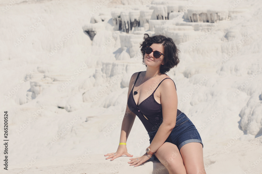 Fototapeta premium Beautiful girl sunbathes on the shore. Relaxation. Vacation Artistic noise