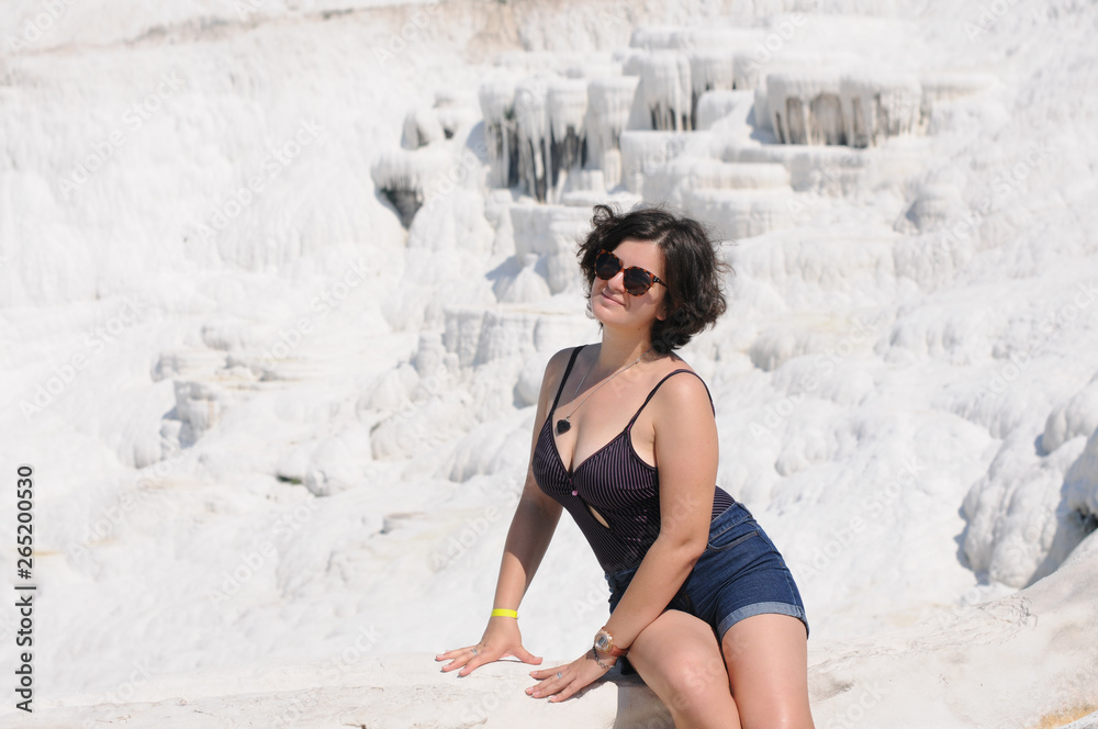Fototapeta premium Beautiful girl sunbathes on the shore. Relaxation. Vacation Artistic noise