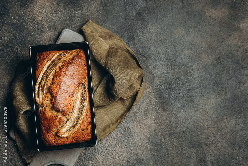 Banana bread with nuts, honey and mint on a dark background.