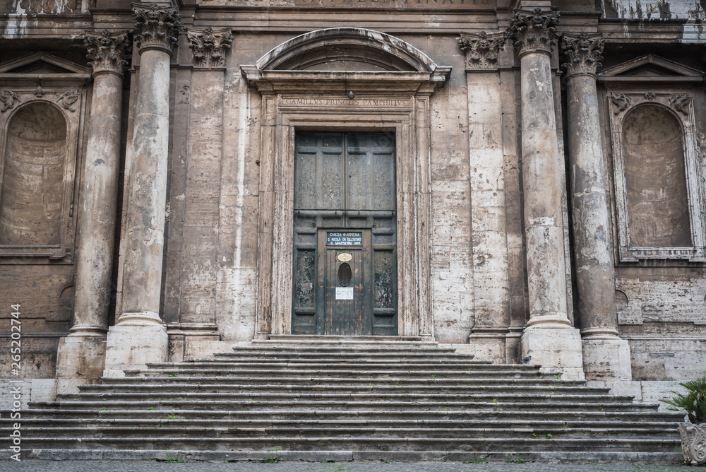 Fototapeta premium Stairs leading into an ancient church in Rome