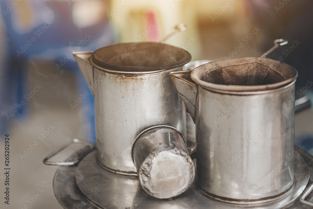 Antique coffee pot with floating smoke,Making Thai coffee using coffee bag in ancient Stainless