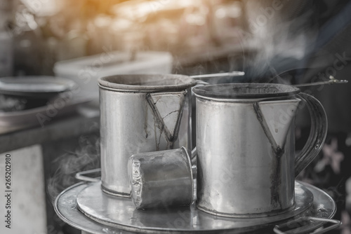 Antique coffee pot with floating smoke,Making Thai coffee using coffee bag in ancient Stainless Steel Pot,coffee shop on street food in Thailand,Vintage color