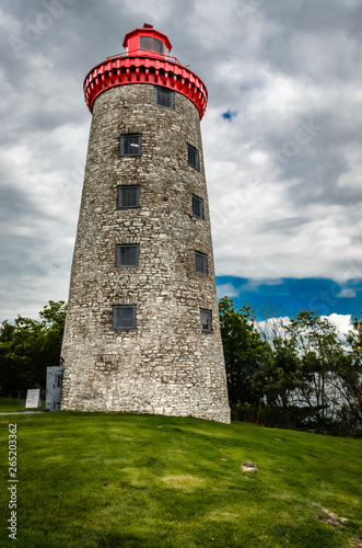 Old stone lighthouse against a gray sky