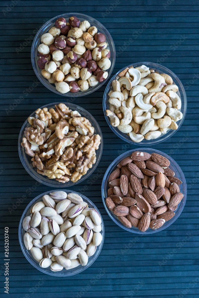 Healthy food. Nuts mix assortment on stone texture top view. Collection of different legumes for background image close up nuts, pistachios, almond, cashew nuts, peanut, walnut. image