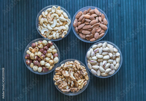 Healthy food. Nuts mix assortment on stone texture top view. Collection of different legumes for background image close up nuts  pistachios  almond  cashew nuts  peanut  walnut. image