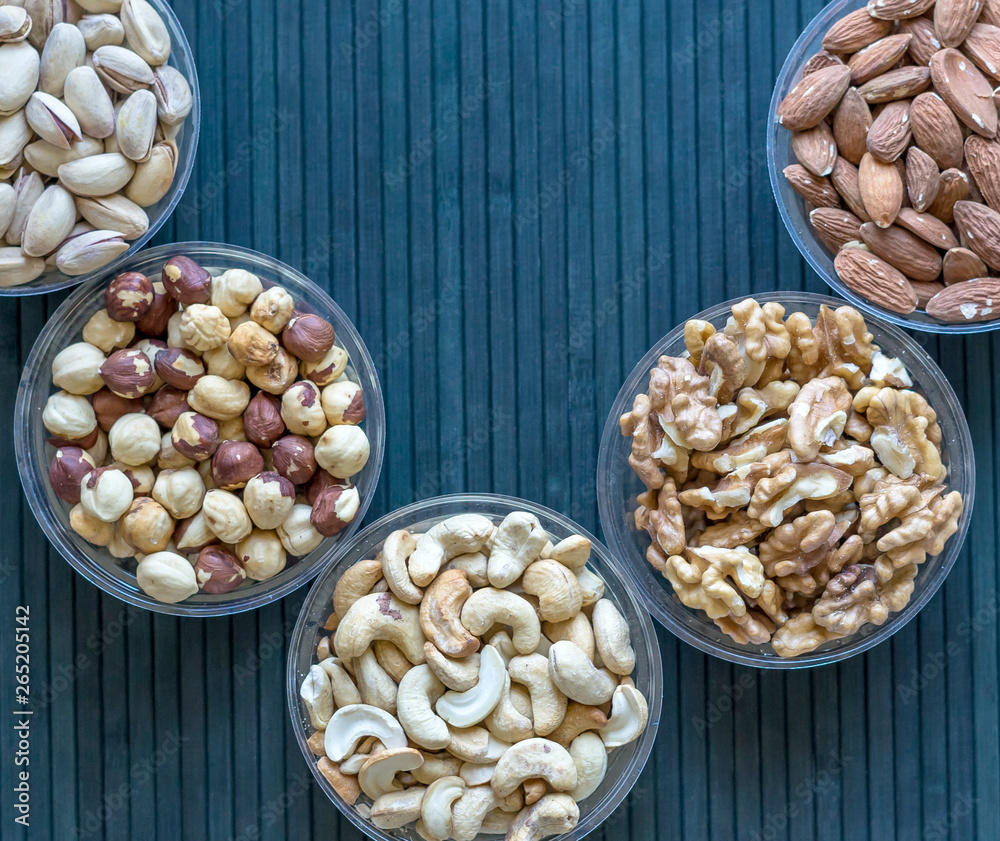 Healthy food. Nuts mix assortment on stone texture top view. Collection of different legumes for background image close up nuts, pistachios, almond, cashew nuts, peanut, walnut. image Healthy food. Nuts mix assortment on stone texture top view. Collection of different legumes for background image close up nuts, pistachios, almond, cashew nuts, peanut, walnut. image