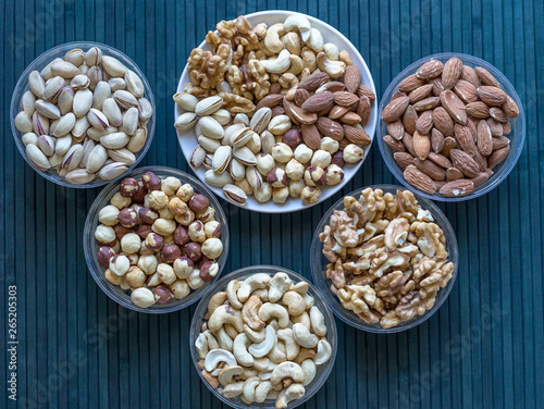Healthy food. Nuts mix assortment on stone texture top view. Collection of different legumes for background image close up nuts, pistachios, almond, cashew nuts, peanut, walnut. image © Evgenia