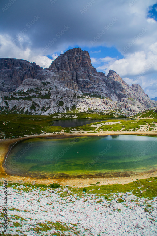 Scenic landscape panoramic view of idyllic mountains and lakes scene in summer on Tre Cime di Lavaredo(Drei Zinnen) hiking/walking trail in Sexten Dolomites, Italy. Beautiful alpine panorama.