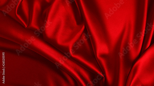 Red silk or satin luxury fabric texture can use as abstract background. Top view.