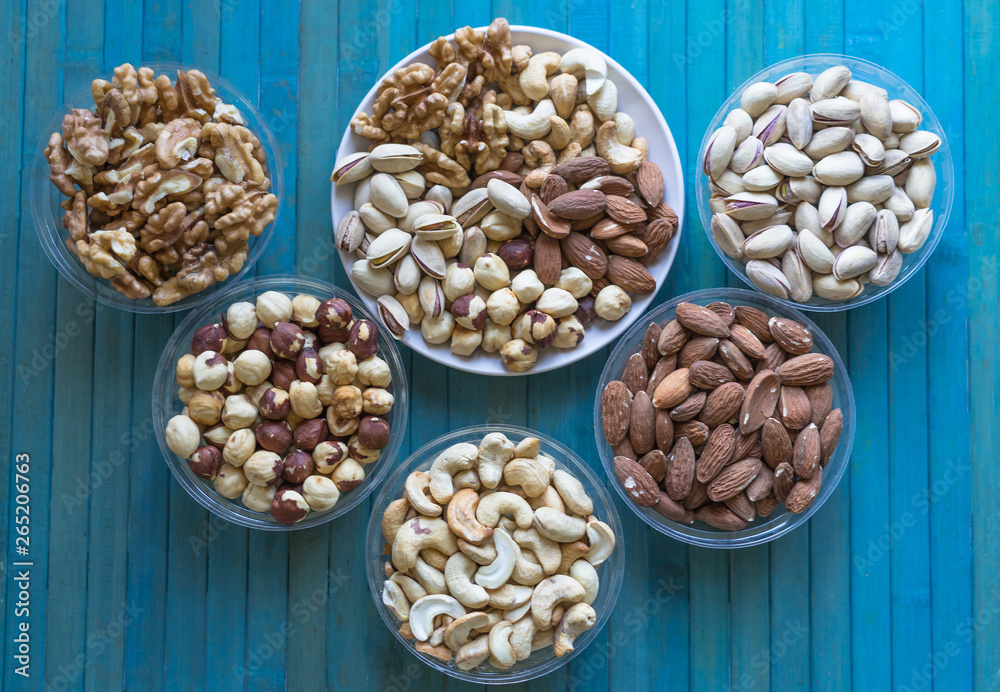 Healthy food. Nuts mix assortment on texture top view. Collection of different legumes for background image close up nuts, pistachios, almond, cashew nuts, peanut, walnut. image Healthy food. Nuts mix assortment on texture top view. Collection of different legumes for background image close up nuts, pistachios, almond, cashew nuts, peanut, walnut. image