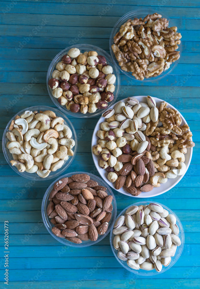 Healthy food. Nuts mix assortment on texture top view. Collection of different legumes for background image close up nuts, pistachios, almond, cashew nuts, peanut, walnut. image Healthy food. Nuts mix assortment on texture top view. Collection of different legumes for background image close up nuts, pistachios, almond, cashew nuts, peanut, walnut. image