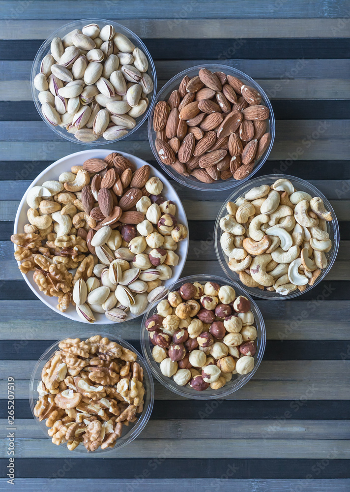 Healthy food. Nuts mix assortment on texture top view. Collection of different legumes for background image close up nuts, pistachios, almond, cashew nuts, peanut, walnut. image Healthy food. Nuts mix assortment on texture top view. Collection of different legumes for background image close up nuts, pistachios, almond, cashew nuts, peanut, walnut. image