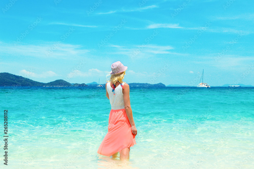 Happy dreamer traveler, young girl on the beach on holidays on the islands, enjoying the ocean view on a sunny bright day Happy dreamer traveler, young girl on the beach on holidays on the islands, enjoying the ocean view on a sunny bright day